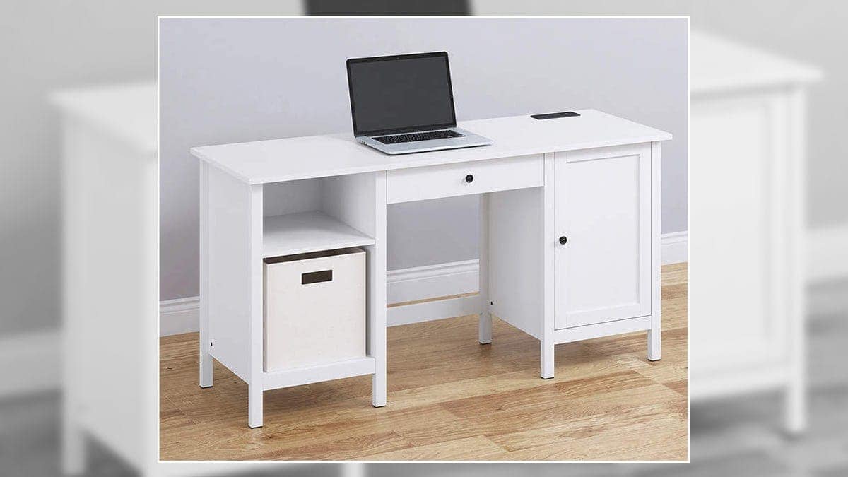 a laptop on a white laptop table.
