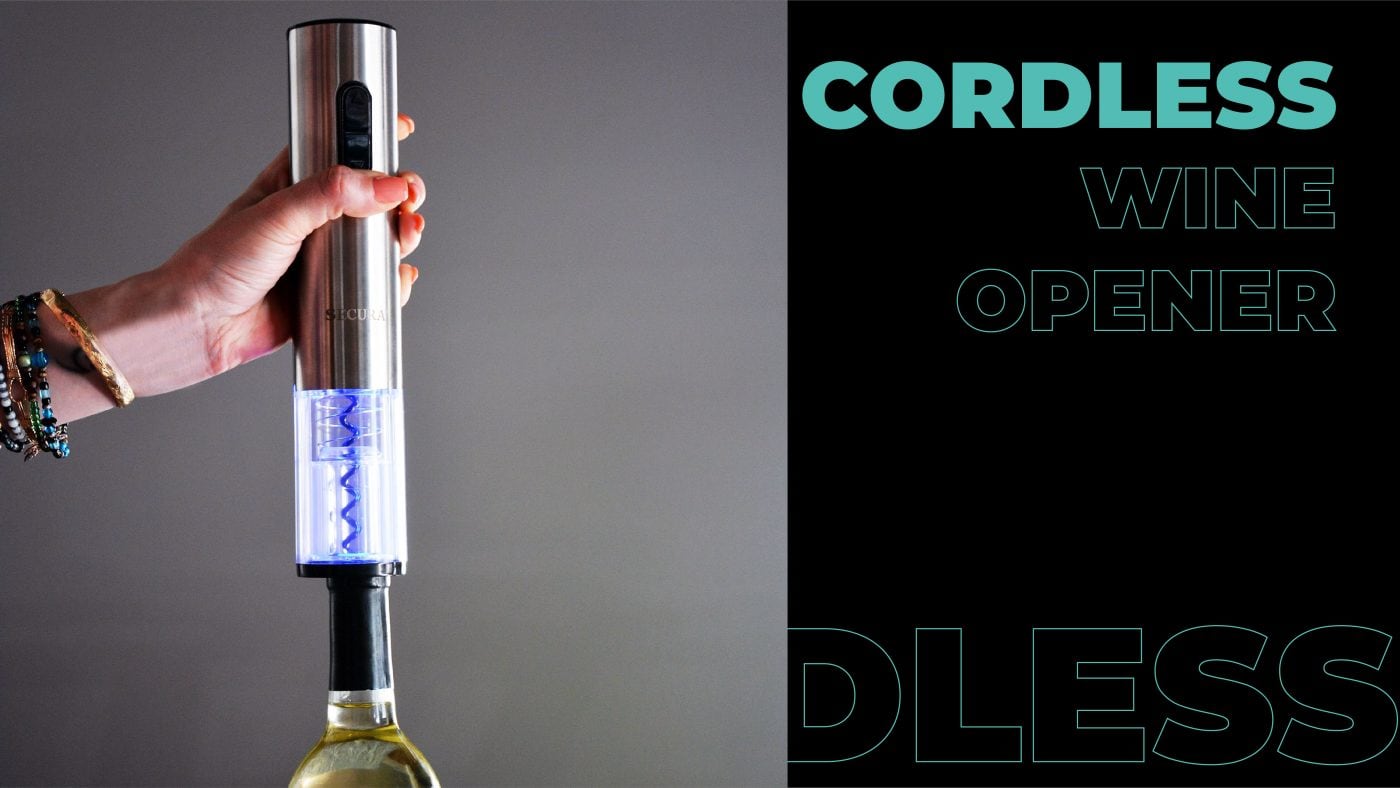 a person opening a wine bottle with a cordless wine opener. 