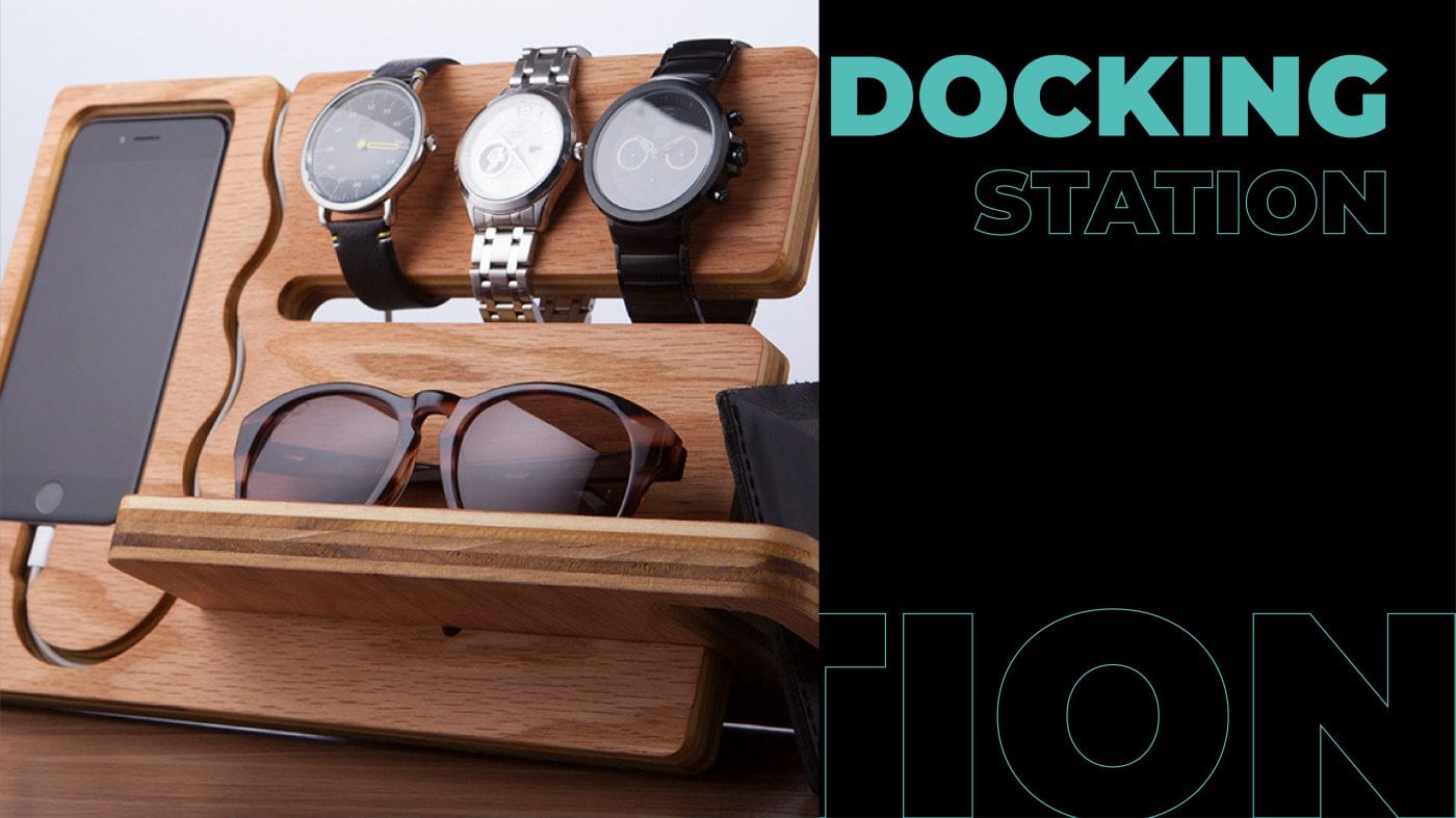 A wooden Docking station with phone, watches, and sunglasses. 