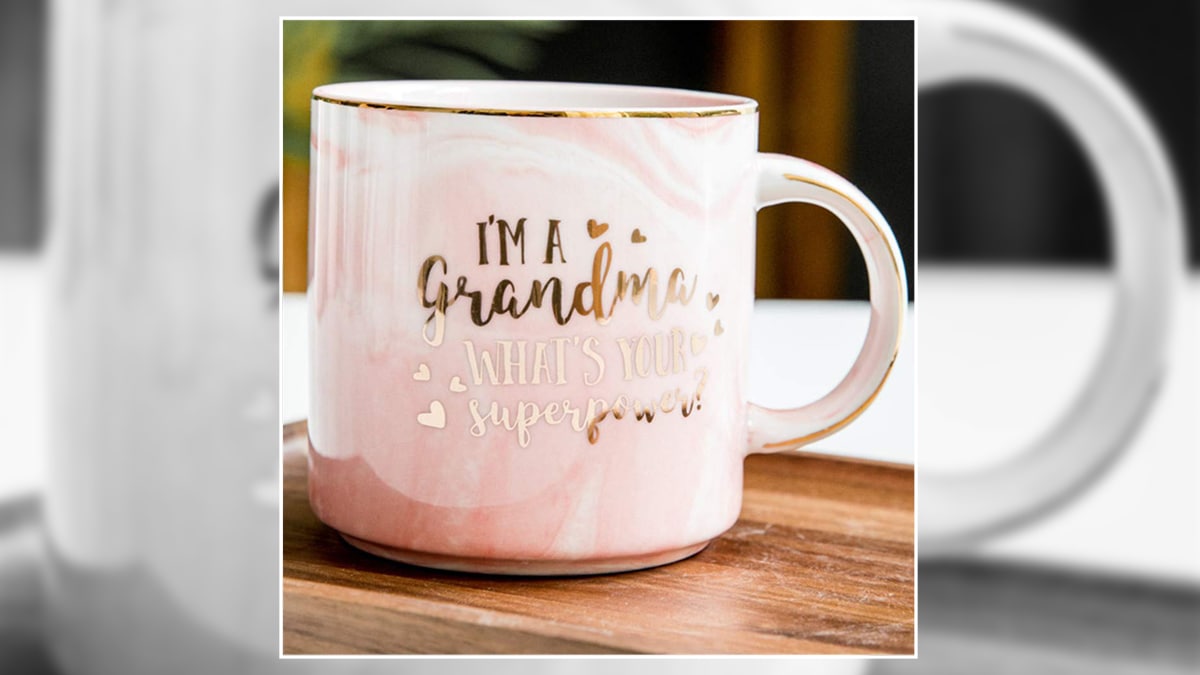 A light-pink grandma mug where "I'm a grandma what's your superpower?' written on it in gold. 