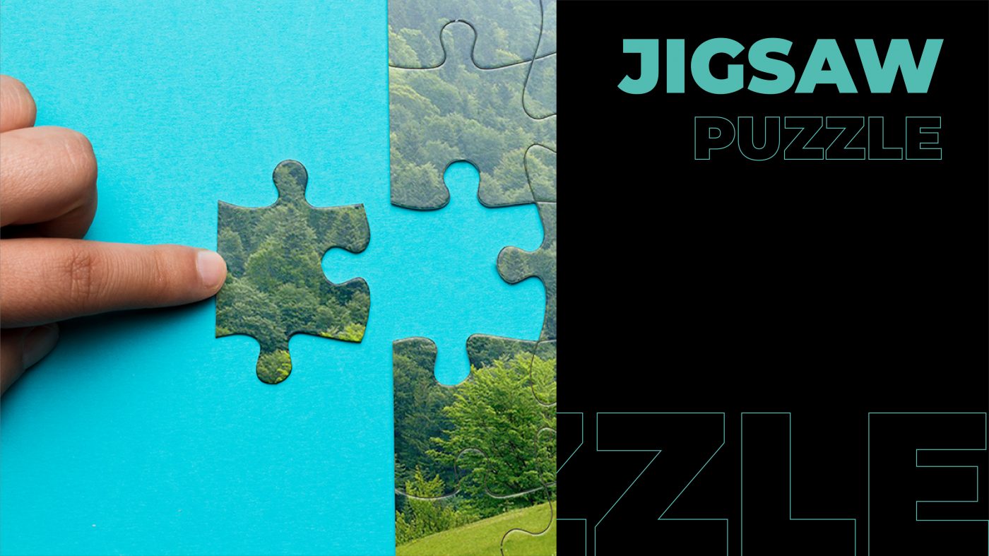 A hand moving a piece of Jigsaw puzzle