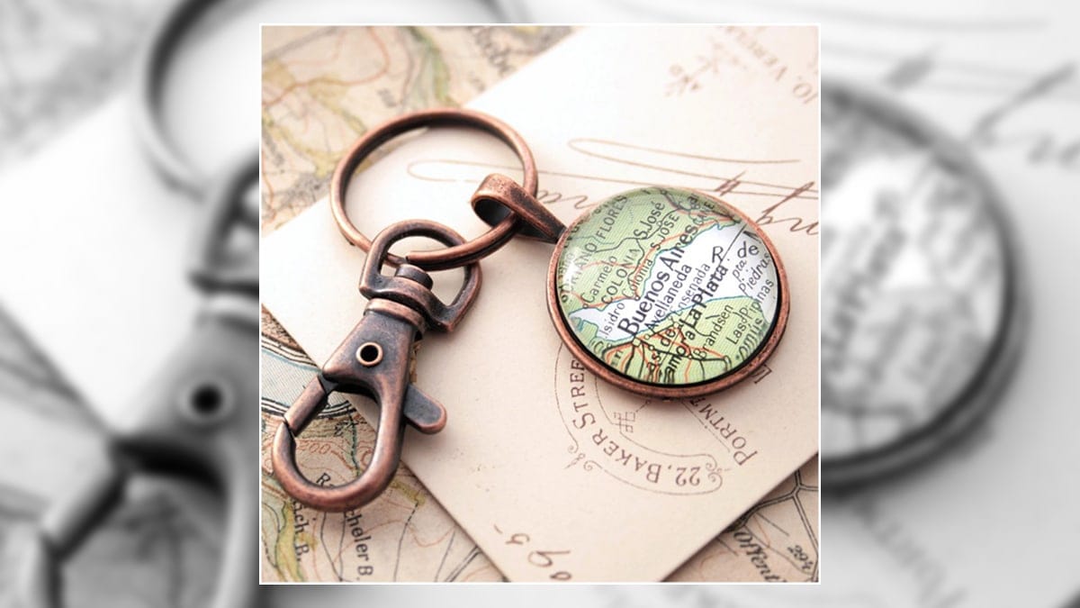 This is a keychain personalized map resting on a map and is one of the other graduation gift ideas for boyfriends.