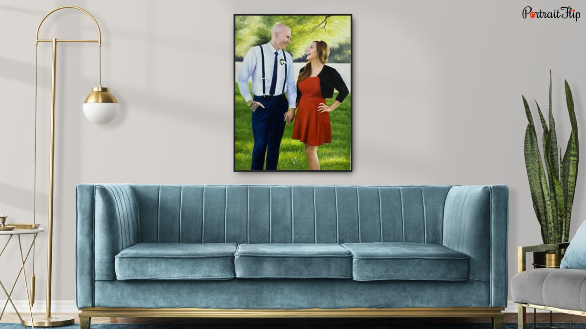 a couple portrait by Portraitflip on the wall above sofa