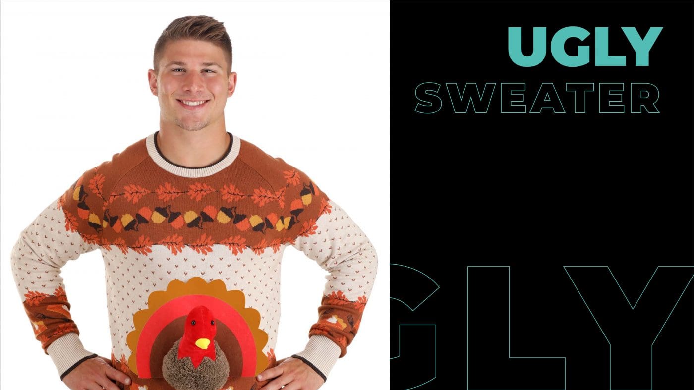 A man wearing ugly sweater of a chicken. 