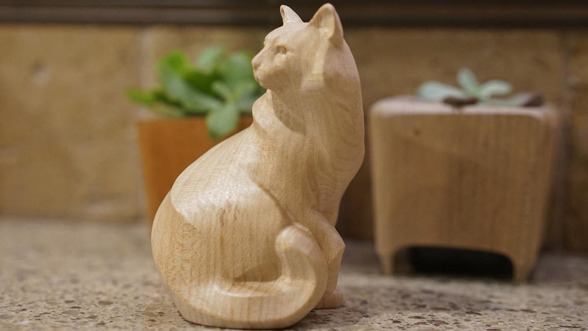a small wooden craved cat figure. 