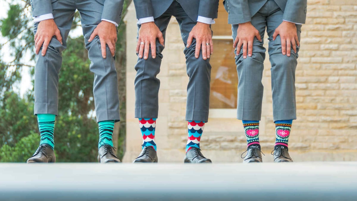 Three pairs of cool socks with people wearing it. These are some of the graduation gift ideas for grandson.