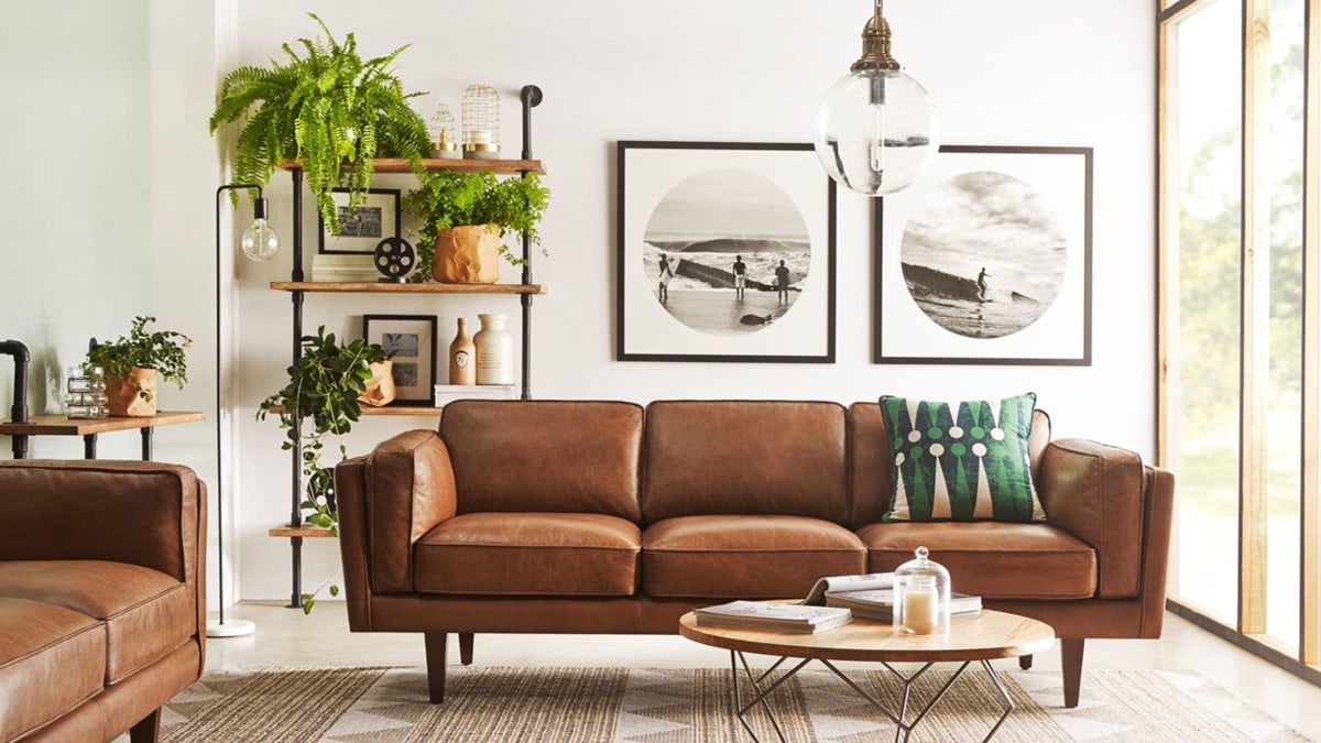 Living room with old fashion furniture and two square sized portrait on the white wall.