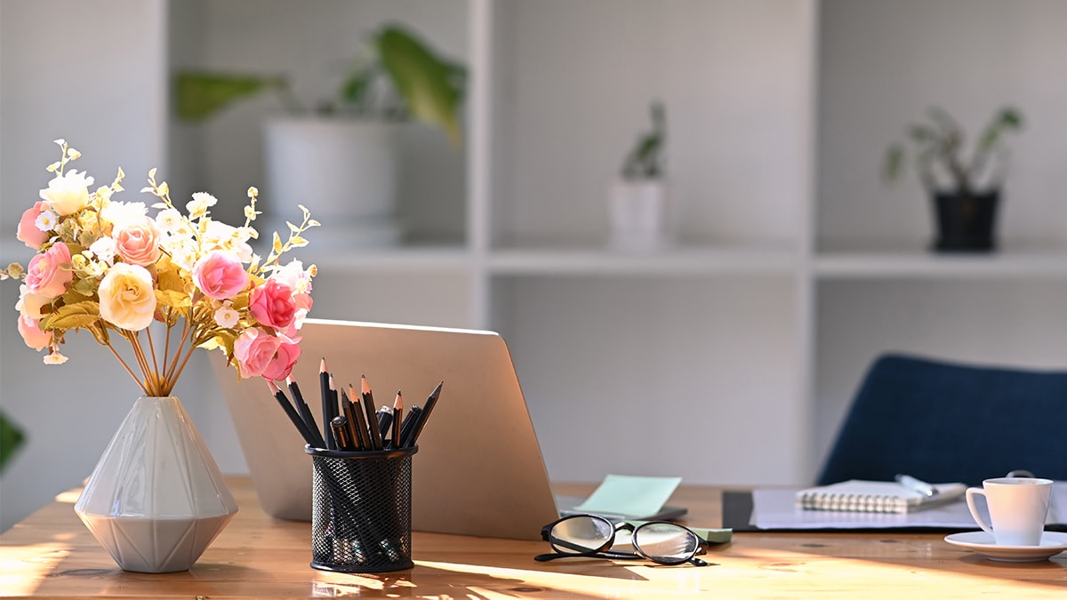 A white flower vase on a work table with beautiful geometrical designs on it