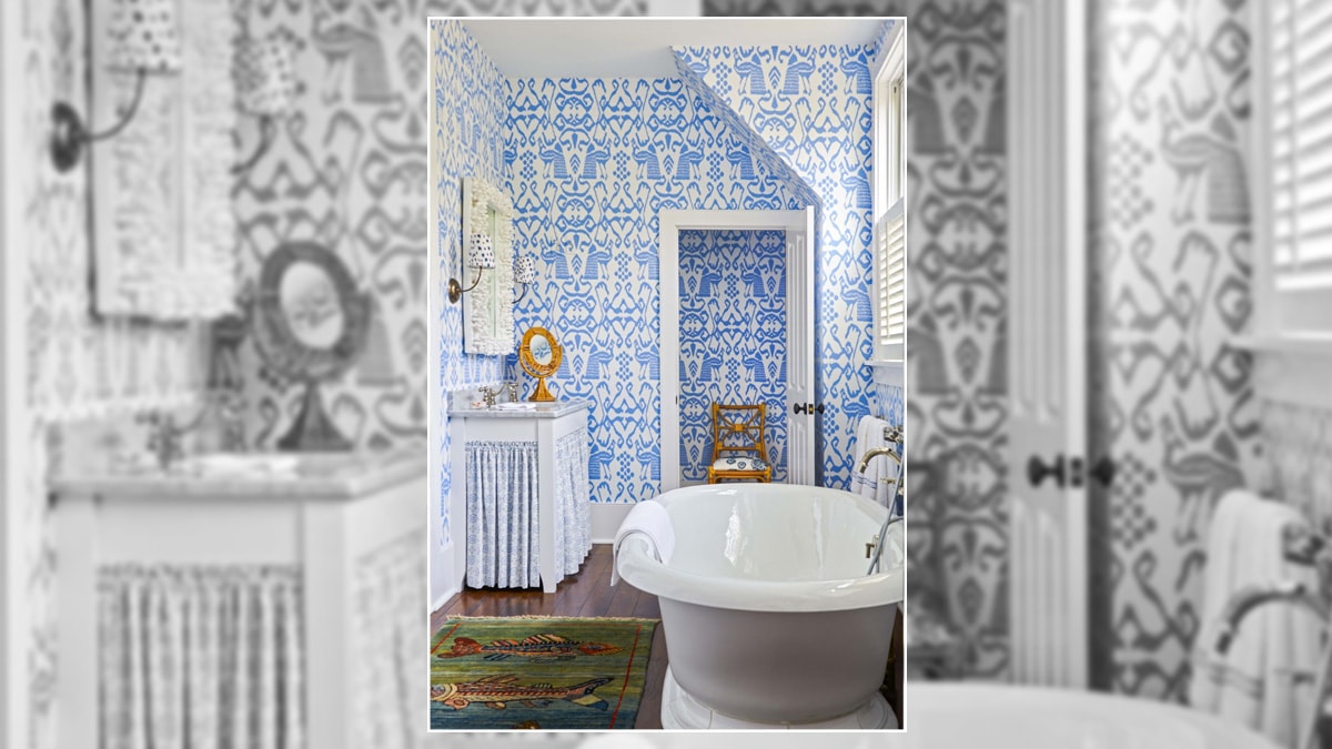 Modern bathroom with a copper jacuzzi and blue accent paint on walls.
