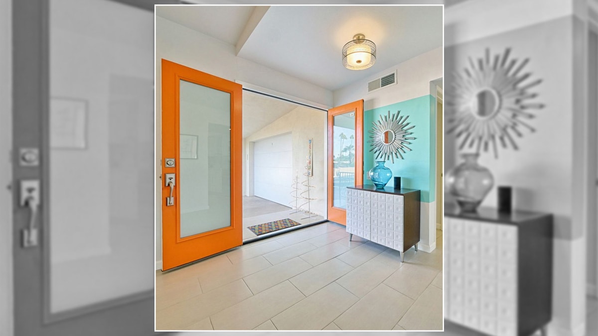 Orange designed frame door in the entryway. 