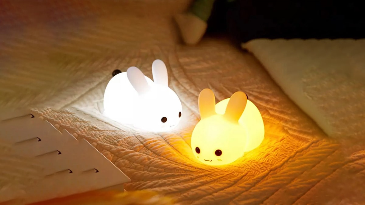 Cute little rabbit night lamps on a bed it is also a gift for rabbit pet lovers.