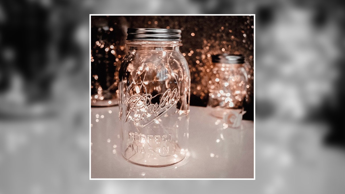 a decorated mason jar with lights in it. 