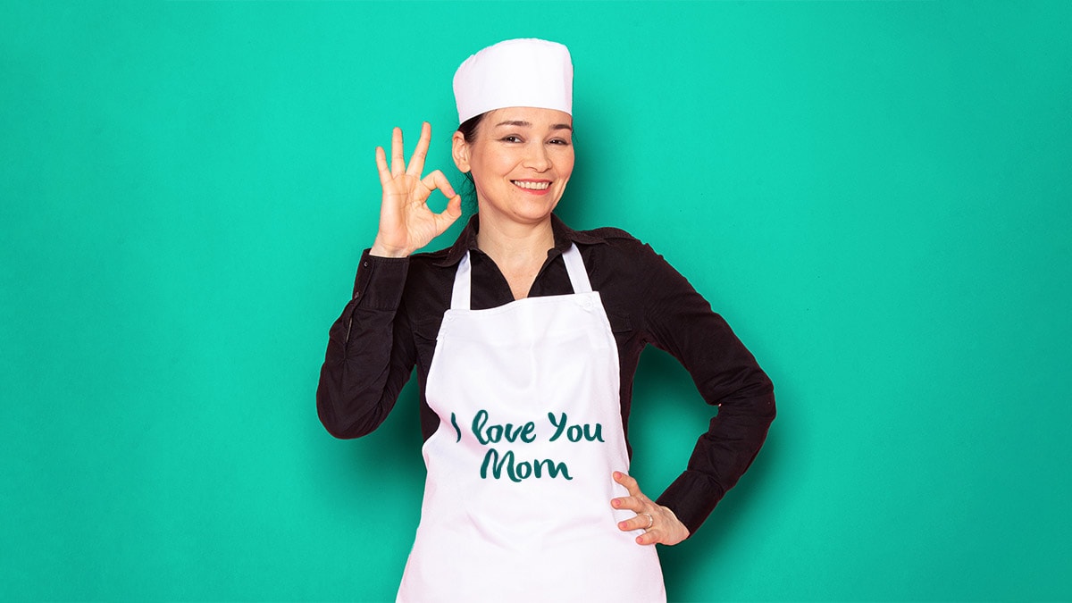 a mom wearing "i love you mom" apron posing for a photo