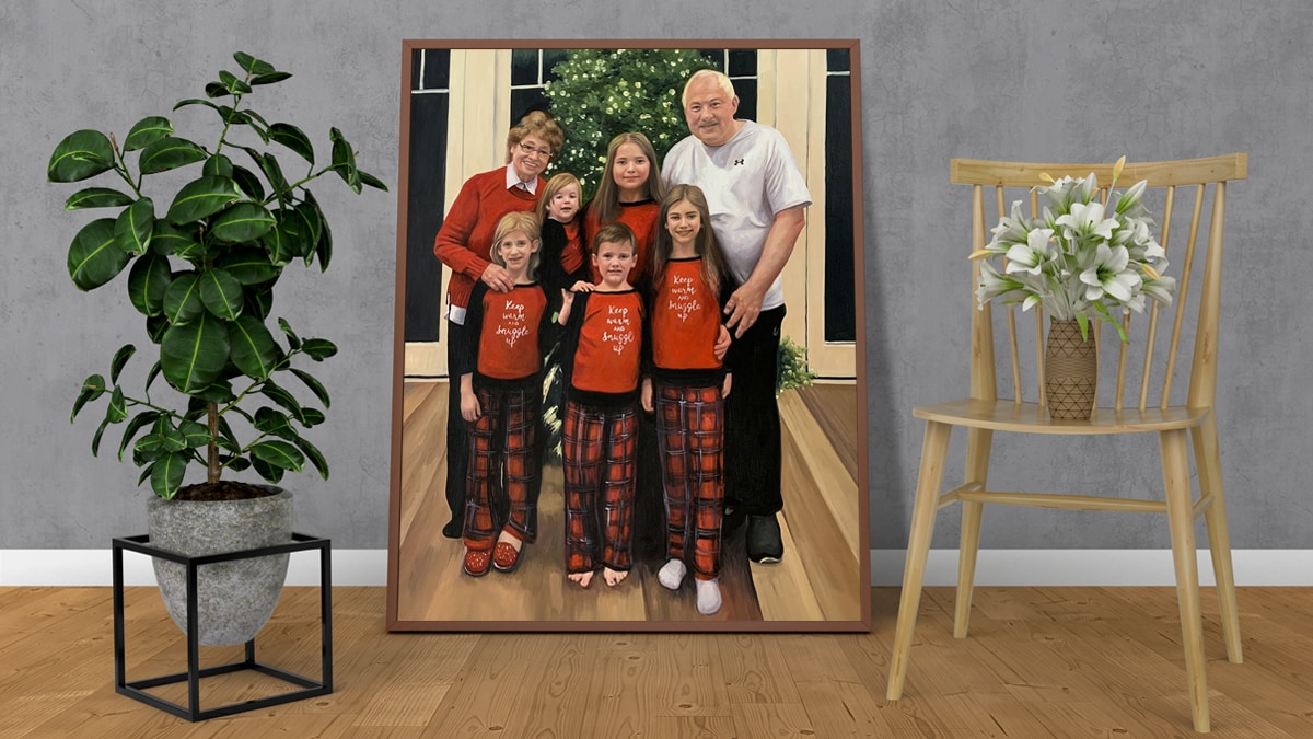 A beautiful photo turned to a handmade custom painting of a whole family all dressed up for Christmas. There is a wooden chair with a plant and there are more plants as well.