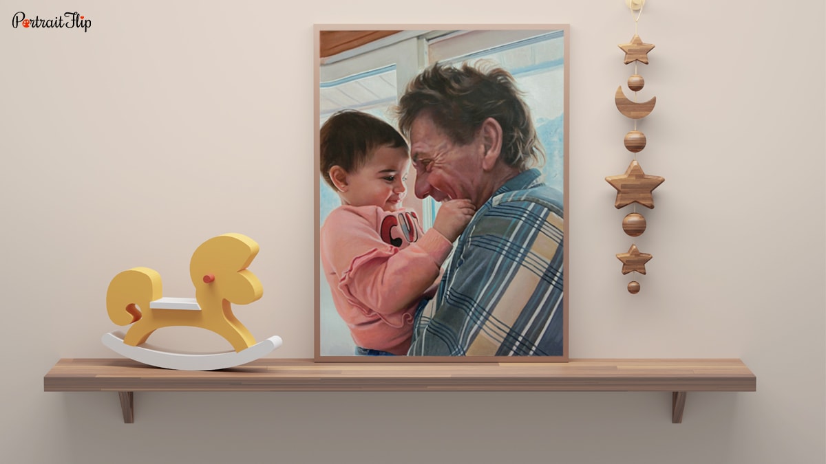 A handmade custom portrait of a baby and father that is sitting on a shelf.
