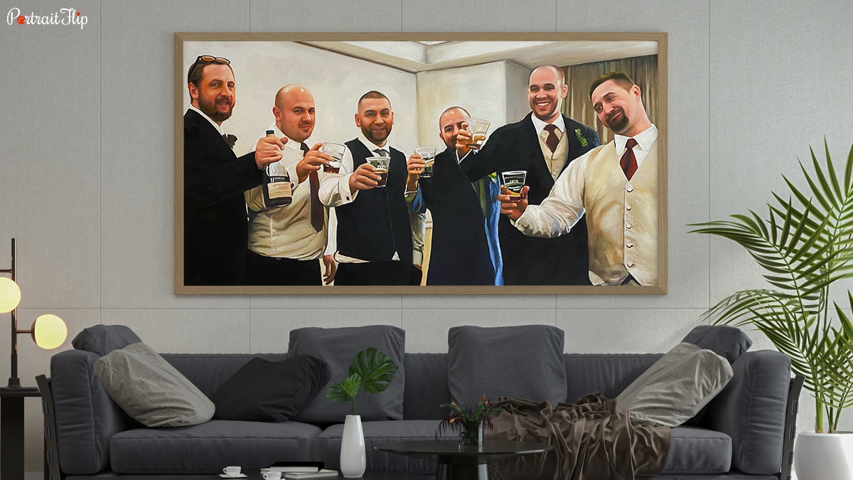 A handmade custom painting as gift for a victory party. It is sitting on a wall, there is a grey couch, plants and some pretty lights as well.