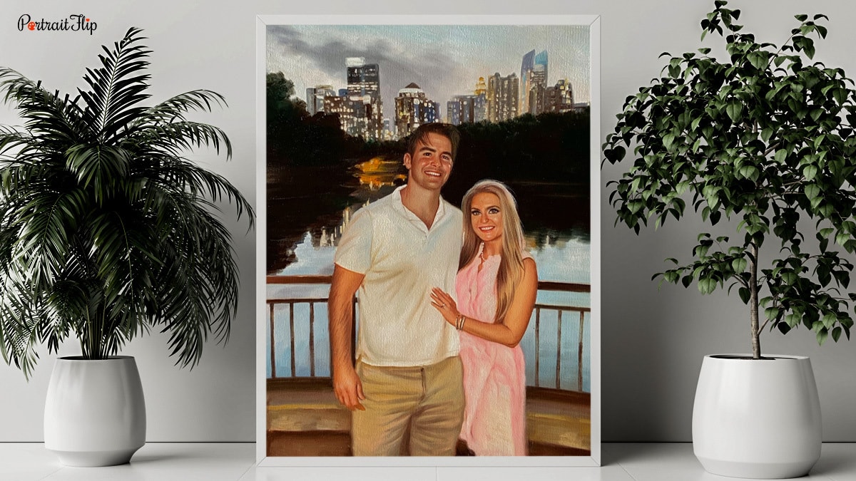A beautiful portrait of two people that are standing next to each other, It is placed on a table with plants surrounding it.