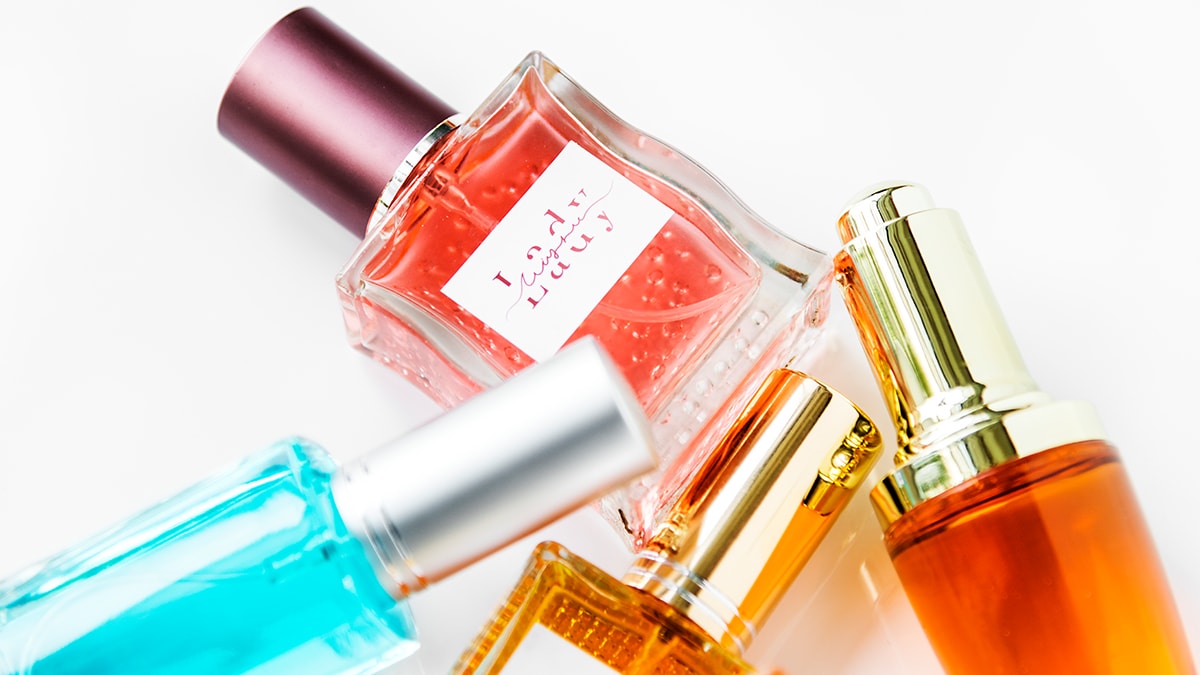 a few colorful perfume sampler bottles on a white background, 