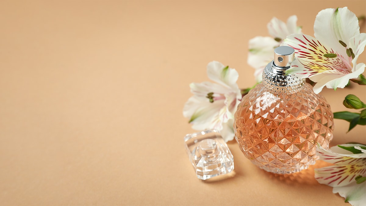 a perfume bottle beside white flowers