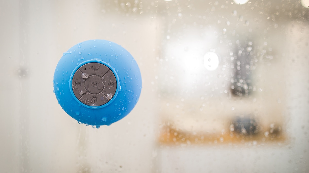 A Bluetooth shower speaker in a bathroom