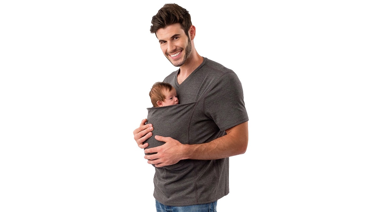 A man holding his baby in his t-shirt carrier