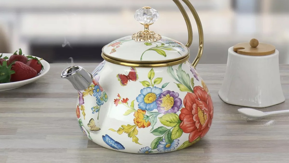 A designer tea kettle with beautiful flower prints on it