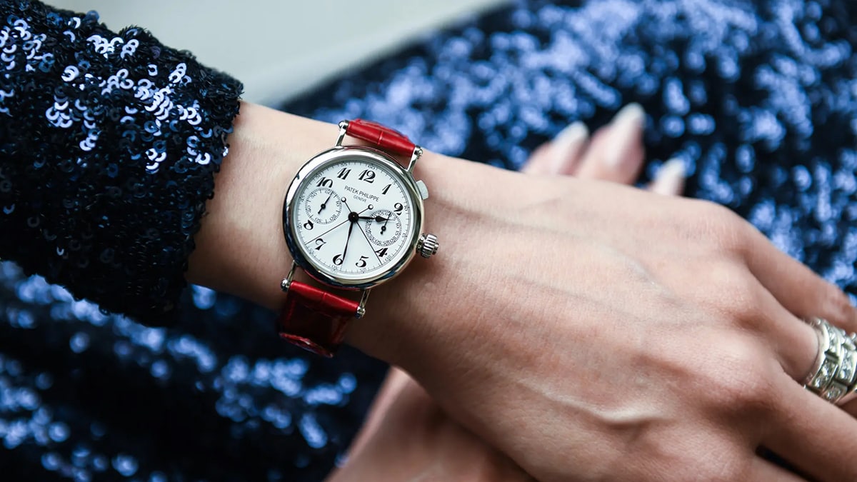 a woman wearing a timepiece on her wrist. 