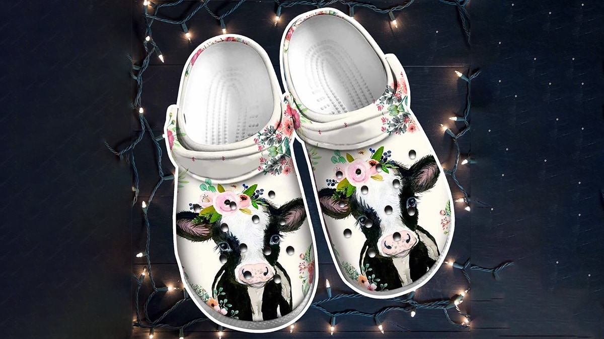 An image with a pair of crocs with cows painting on them in a very beautiful manner.