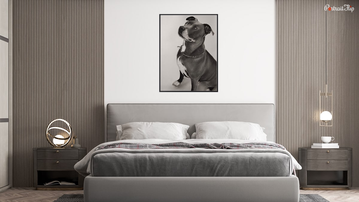 Bedroom space with a dog portrait mounted on the white wall. 