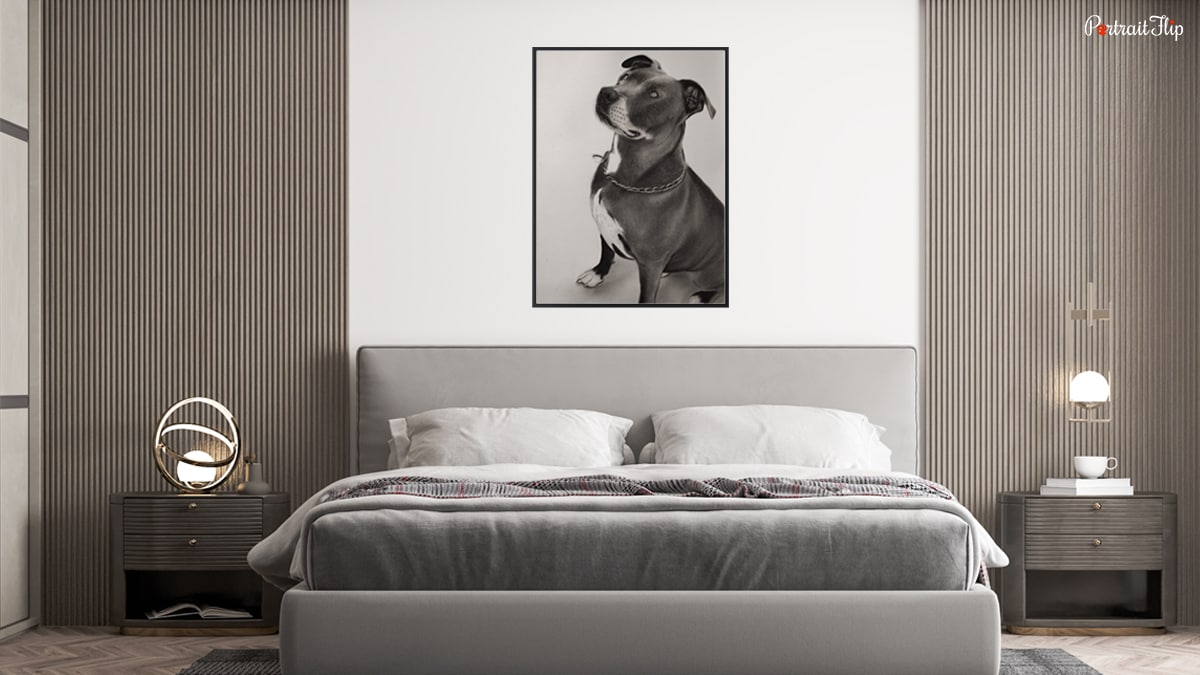 Bedroom space with a dog portrait mounted on the white wall.