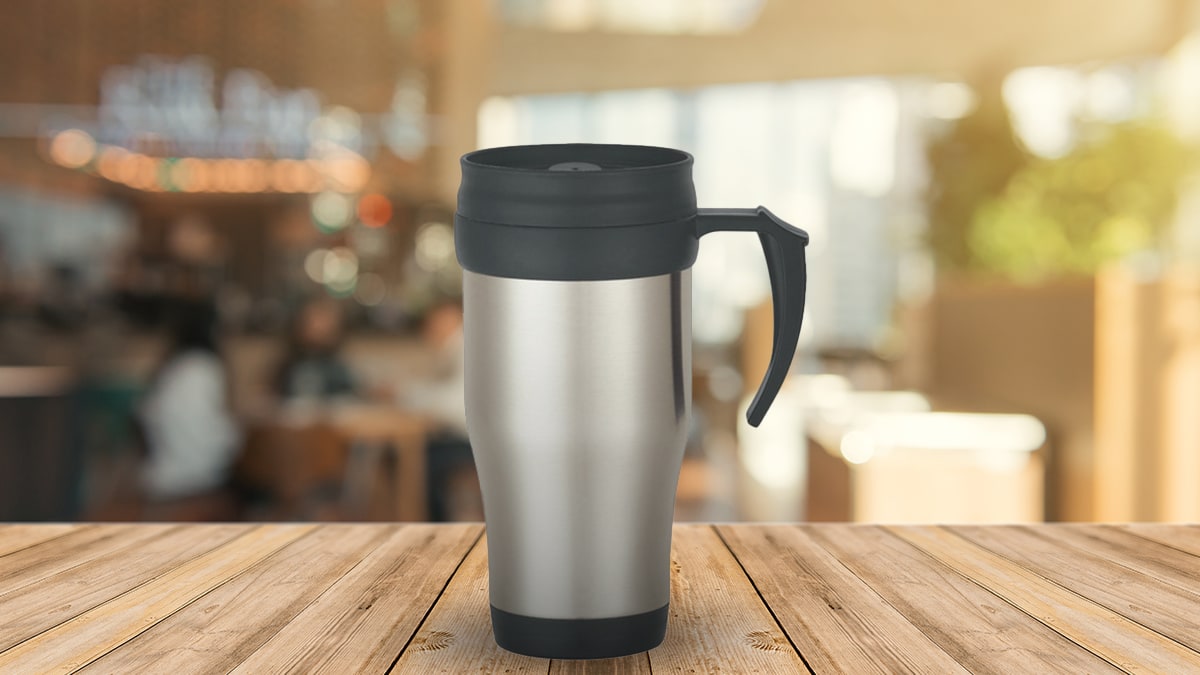 A travel mug on a wooden table