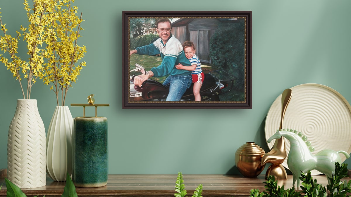 An image in a very pretty interior with a painting portrait of a father and son sitting on a bike. A memorial gift for loss of son.