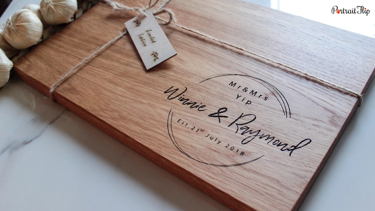 An engraved wooden board that reads Mr and Mrs Yip. Winnie and Raymond Est. 21st July 2018. A wedding gift.