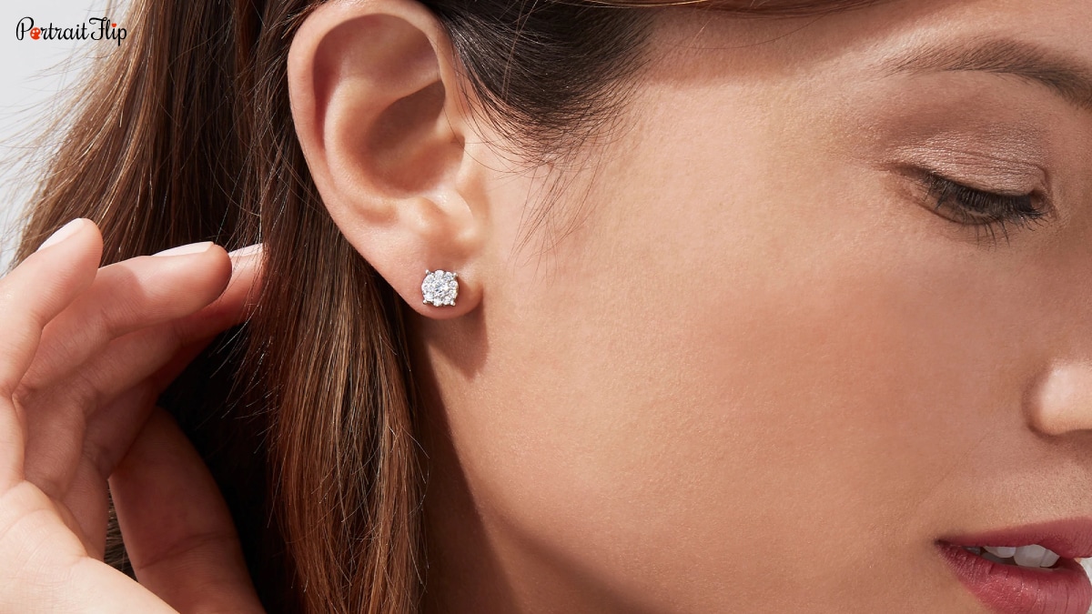 A girl with a diamond earring. It is a gift for wedding.
