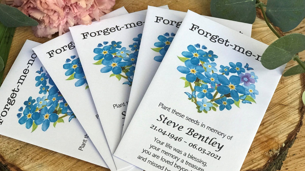Forget me not plants. These are packets with the deceased persons name on it and they are a memorial gift for someone who lost someone they love.