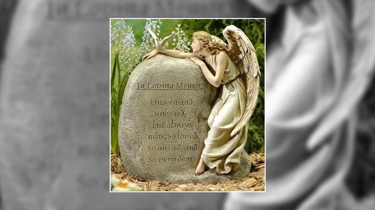 A memorial garden stone with a guardian angel on the stone with a quote on it. It is a gift fro memorial for the loss of a daughter