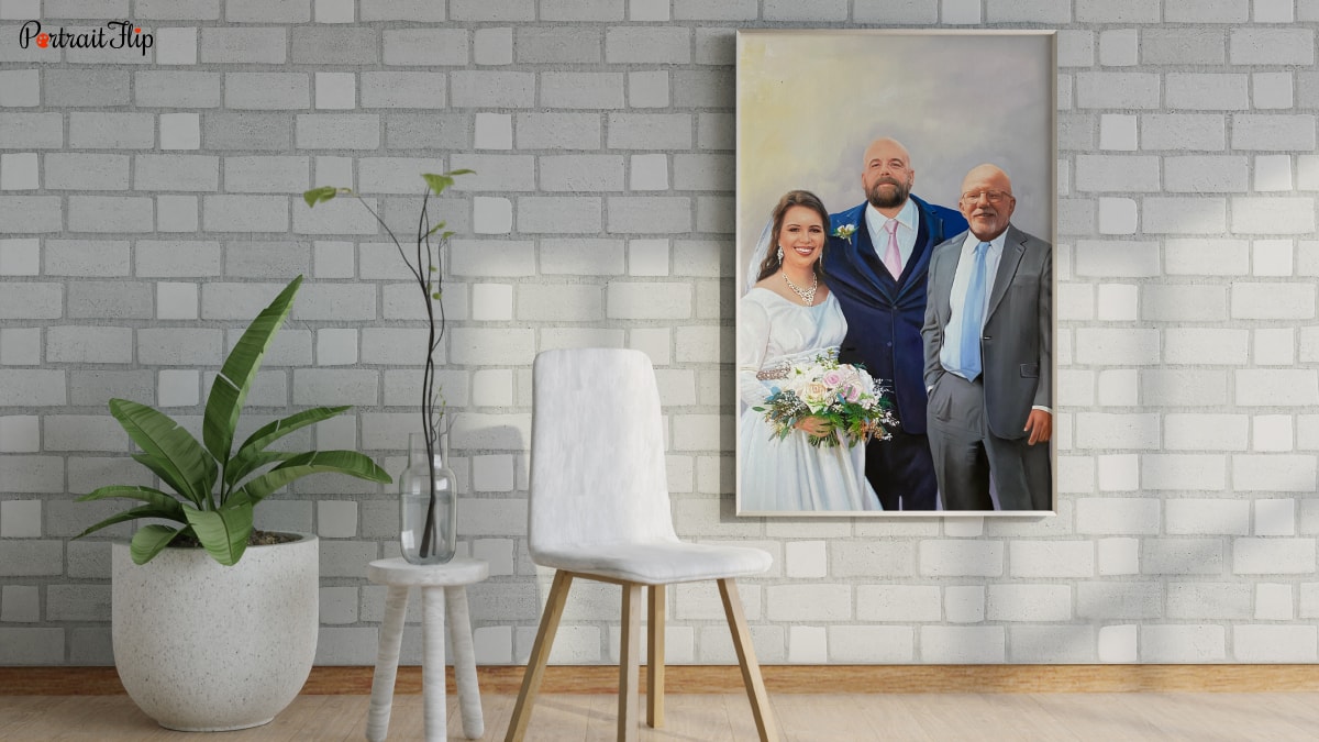 A beautiful interior of a living room with plants and a chair. The wall has a personalized wedding gift that is a custom painting portrait of the bride groom and her deceased father. Incorporated into one portrait.