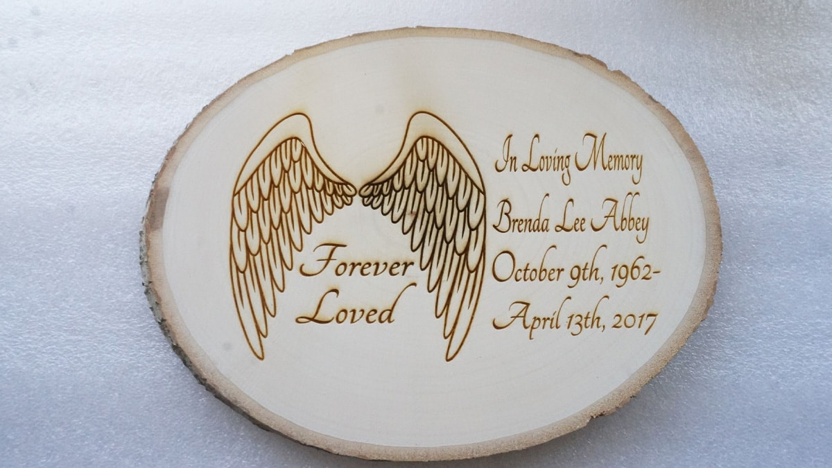 A memorial gift for her, a wood piece etched with a laser and her name as well as a loving quote.
