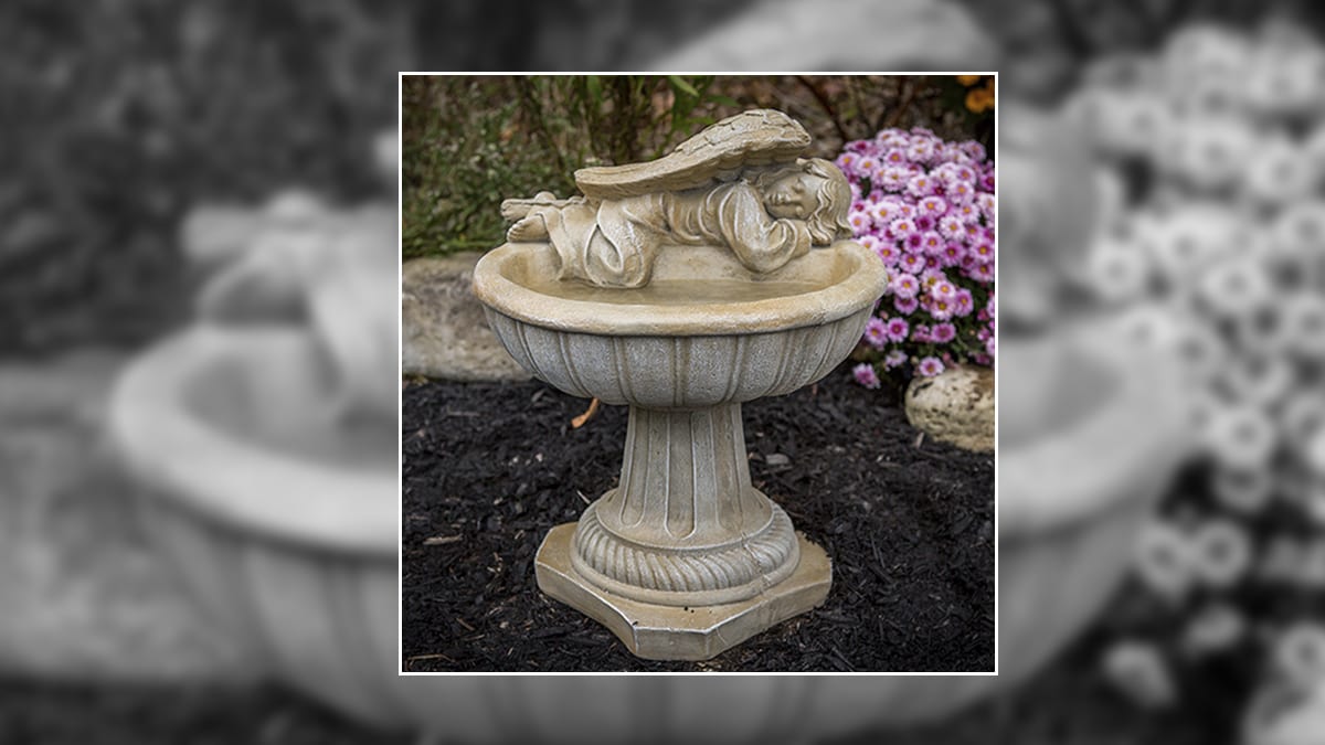 A bird bath with an angel laying on it. A gift for memorial for the loss of a father.