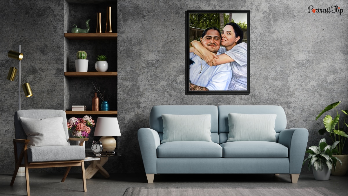 An interior of a living room with a sofa and plants. It is a personalized wedding gift of a painting portrait of a couple.