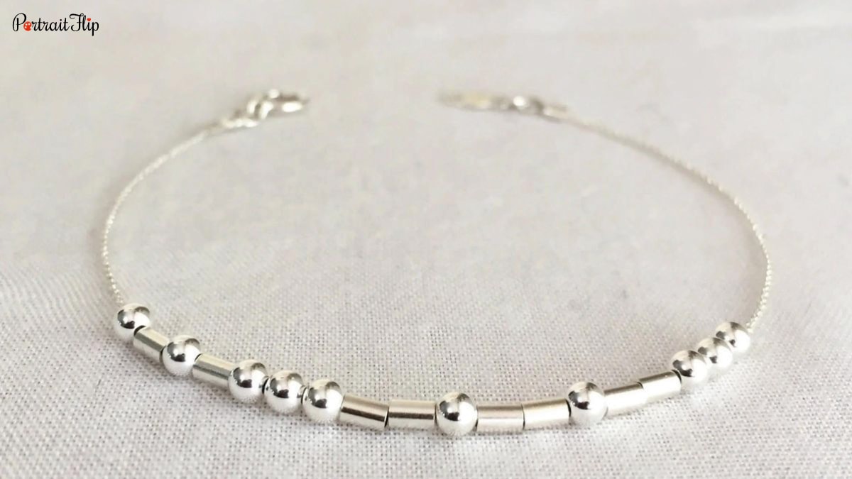 A picture of a bracelet made with morse code. A wedding gift for newly wed couples.