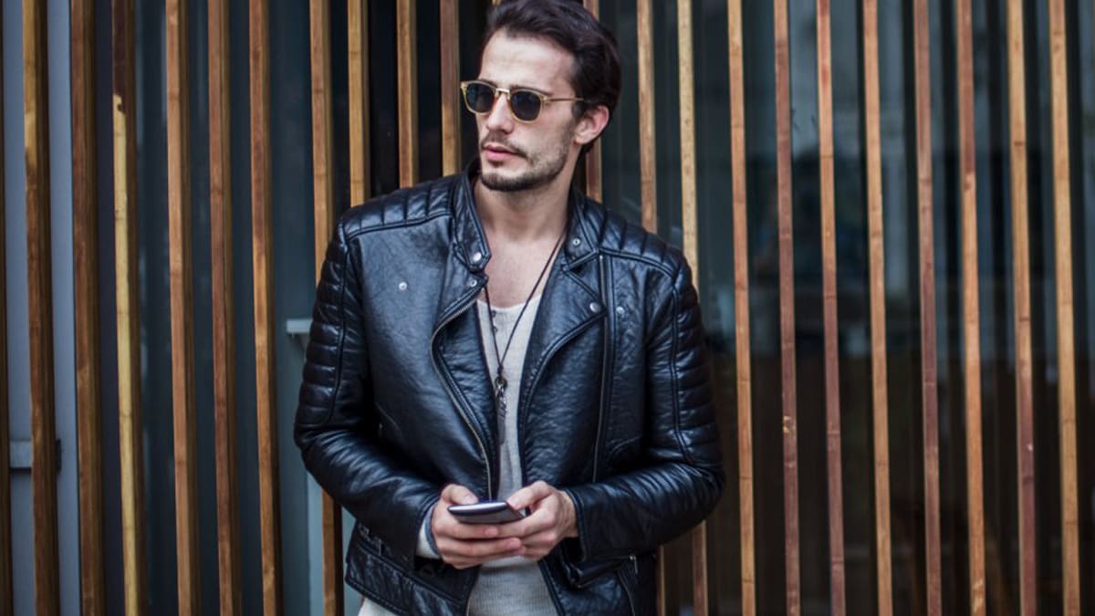 A middle age handsome hunk donned a leather jacket from H&M 