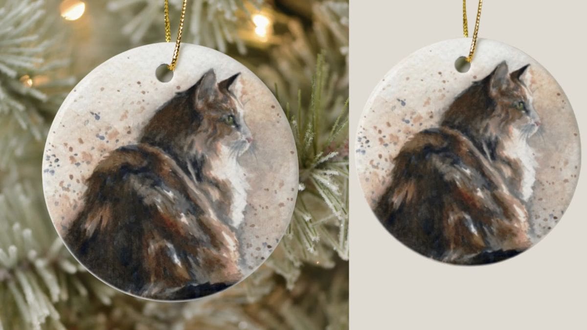 A christmas ornament with a cat painted on it shown as a possible christmas gift for cat lover