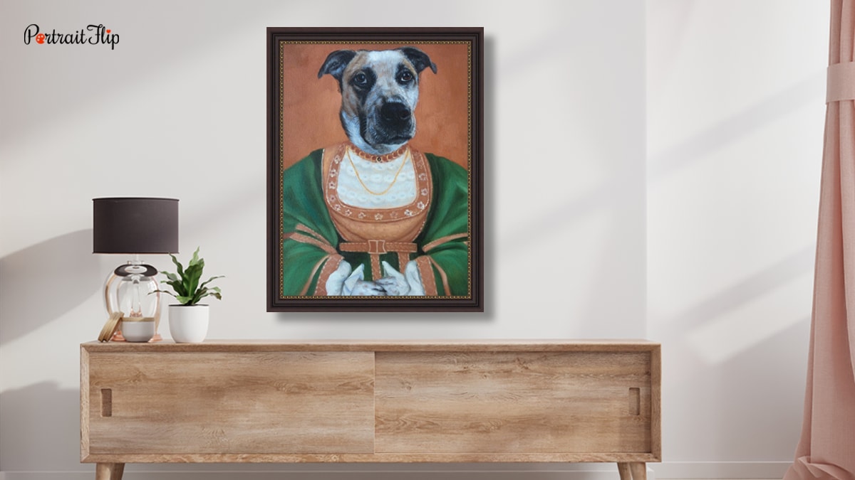 A royal pet portrait of a dog in a kings attire by PortraitFlip. The portrait is placed above a wooden desk in a living room set up. 