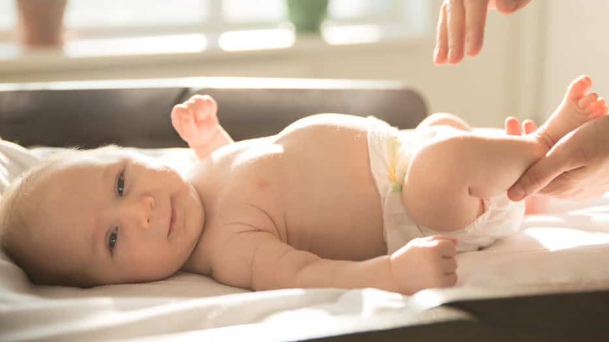 a baby wearing an organic baby diaper made from recyclable materials