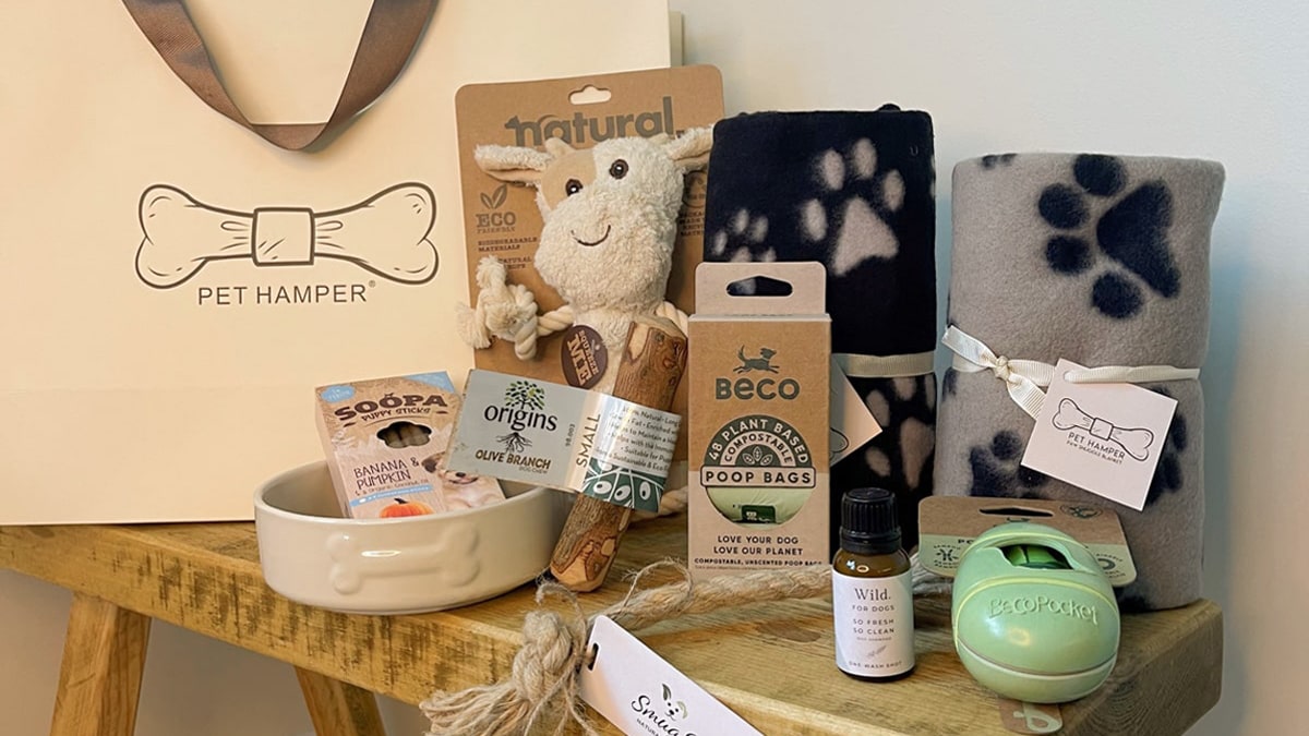 A dog grooming kit with dog products in different variants. The kit has everything from a towel, soaps, poop bags, soft toys, etc