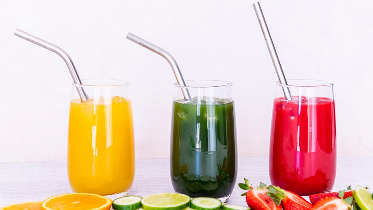 Stainless steel straws in three different flavored juices