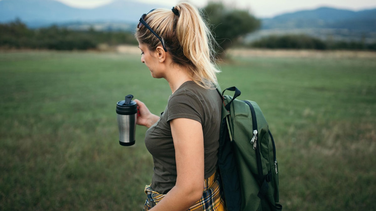 A woman with her thermal travel mug