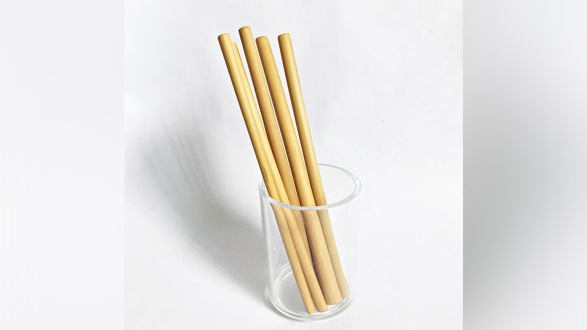 four bamboo straws placed in a glass. 