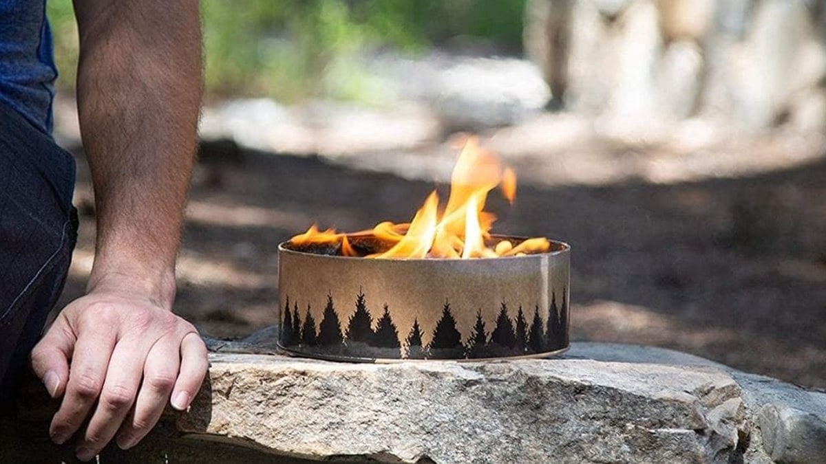 a portable campfire on a rock